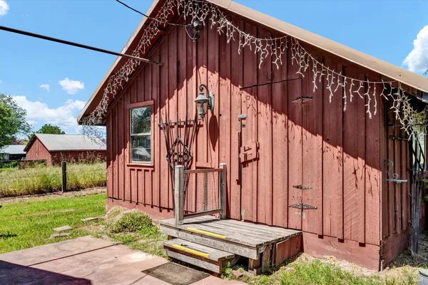 a view of small house with wooden fence