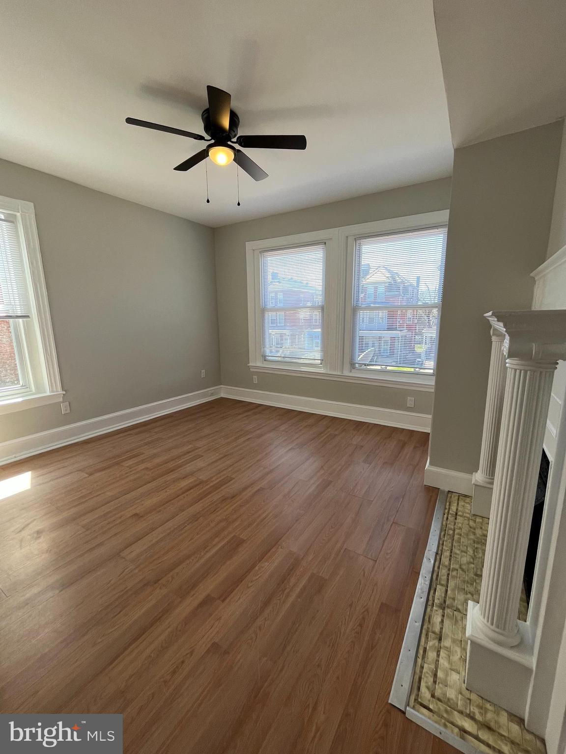 853 Wynnewood Road, Unit 2 Philadelphia, PA 19151 - Photo 2 of 10 a view of an empty room with wooden floor and a window