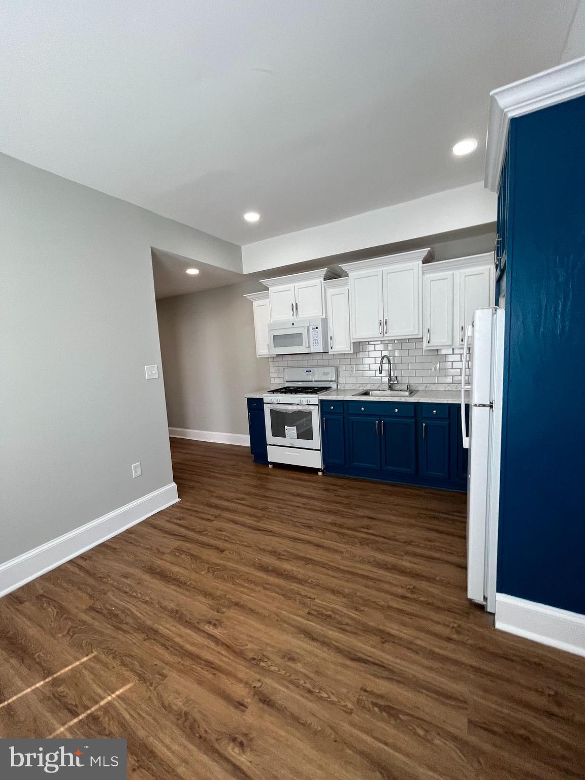 853 Wynnewood Road, Unit 2 Philadelphia, PA 19151 - Photo 8 of 10 a view of kitchen and kitchen with wooden floor