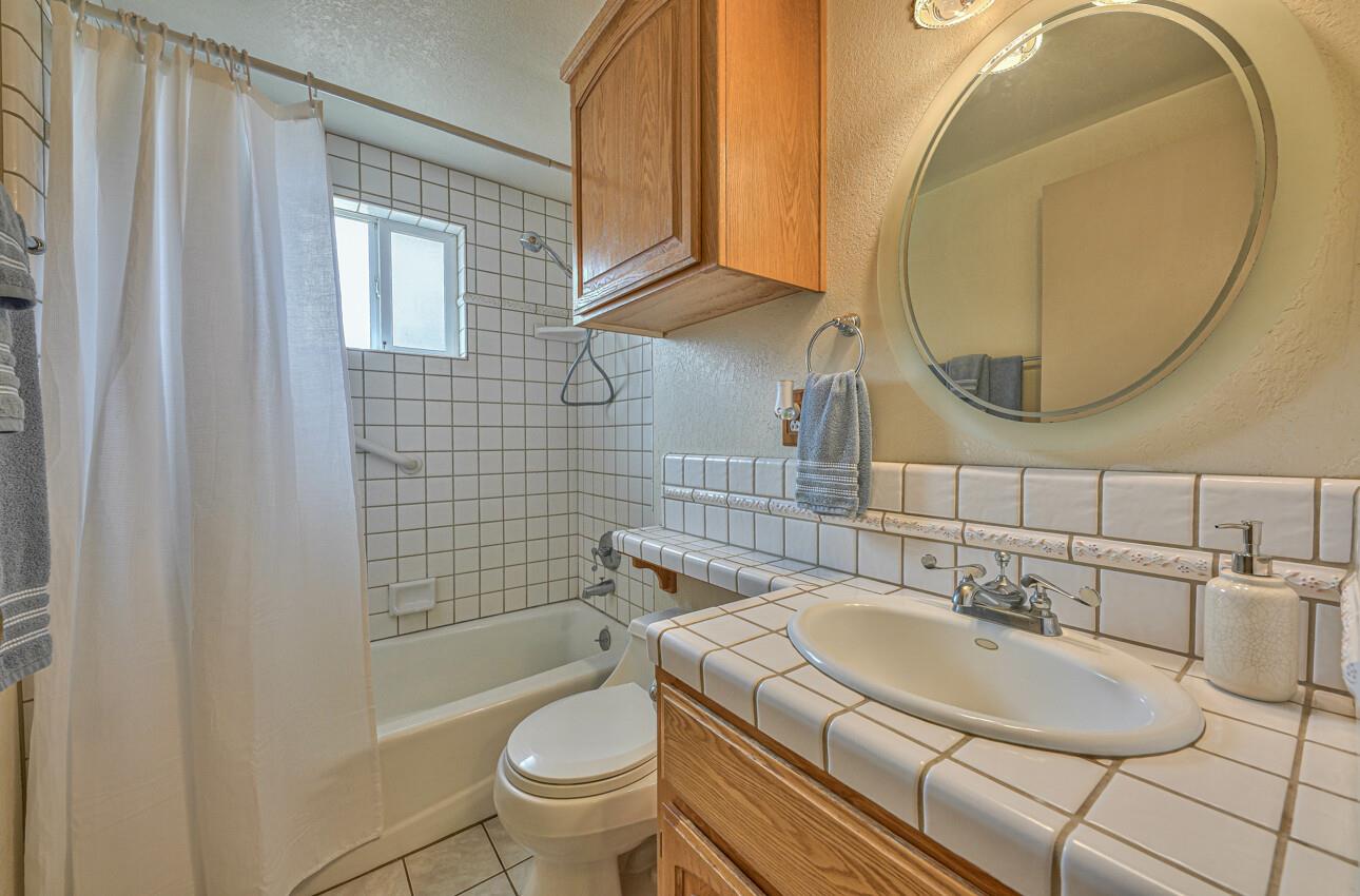759 Middlefield Road Salinas, CA 93906 - Photo 23 of 26 a bathroom with a sink and a mirror