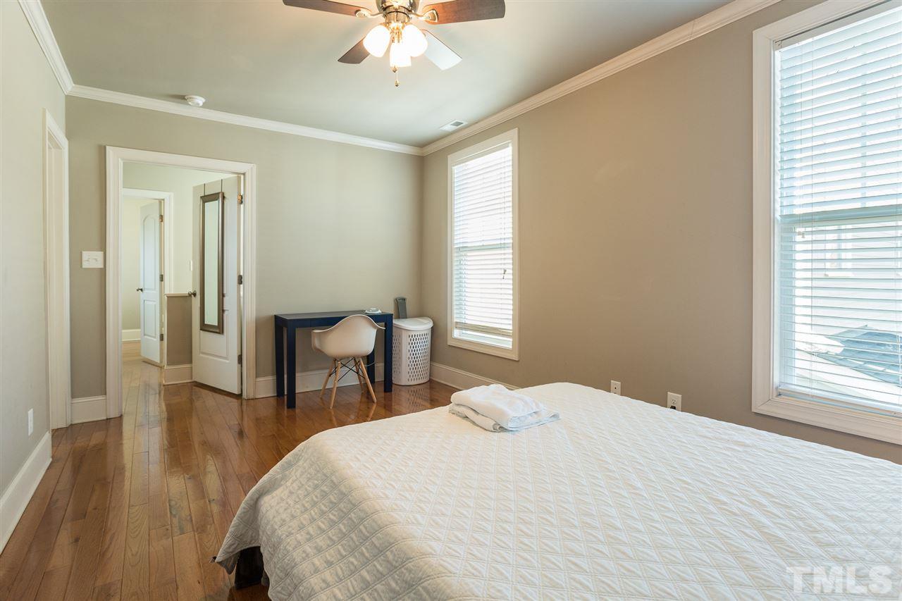 575 East Cabarrus Street Raleigh, NC 27601 - Photo 14 of 20 a bedroom with a bed and a chandelier