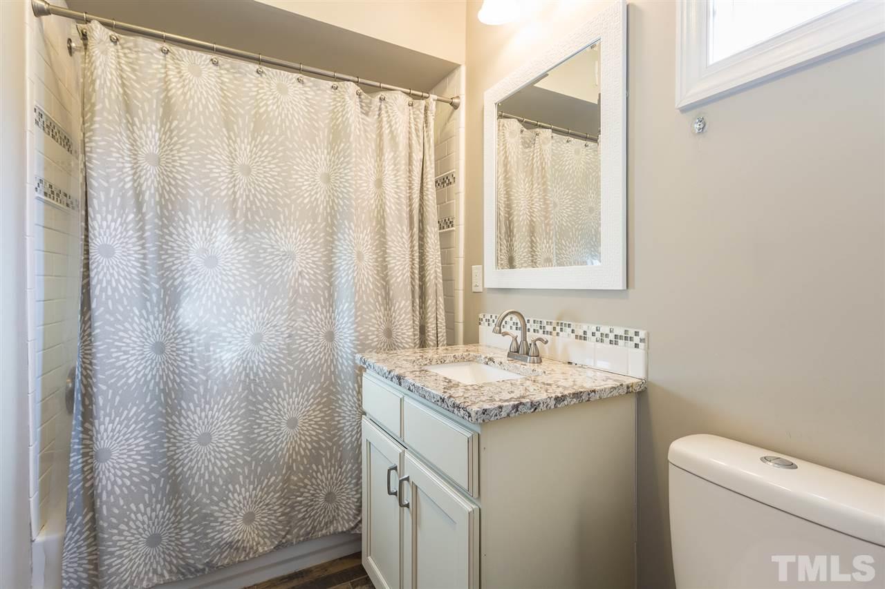575 East Cabarrus Street Raleigh, NC 27601 - Photo 15 of 20 a bathroom with a sink a toilet and a mirror