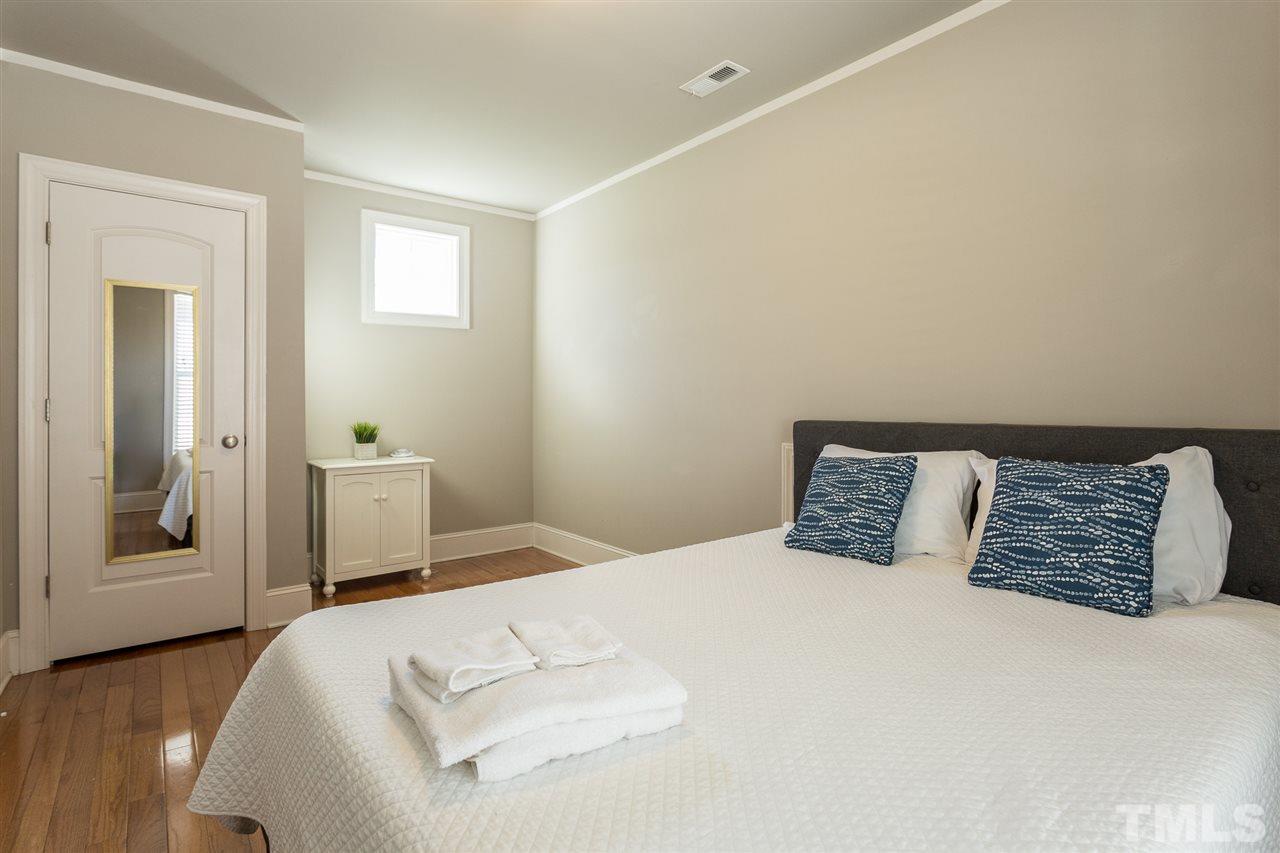 575 East Cabarrus Street Raleigh, NC 27601 - Photo 17 of 20 a bedroom with a large bed and a window