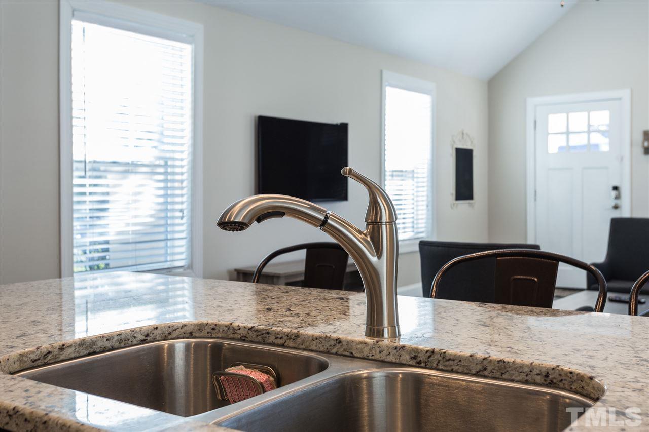 575 East Cabarrus Street Raleigh, NC 27601 - Photo 4 of 20 a kitchen with a granite countertop sink and a large window