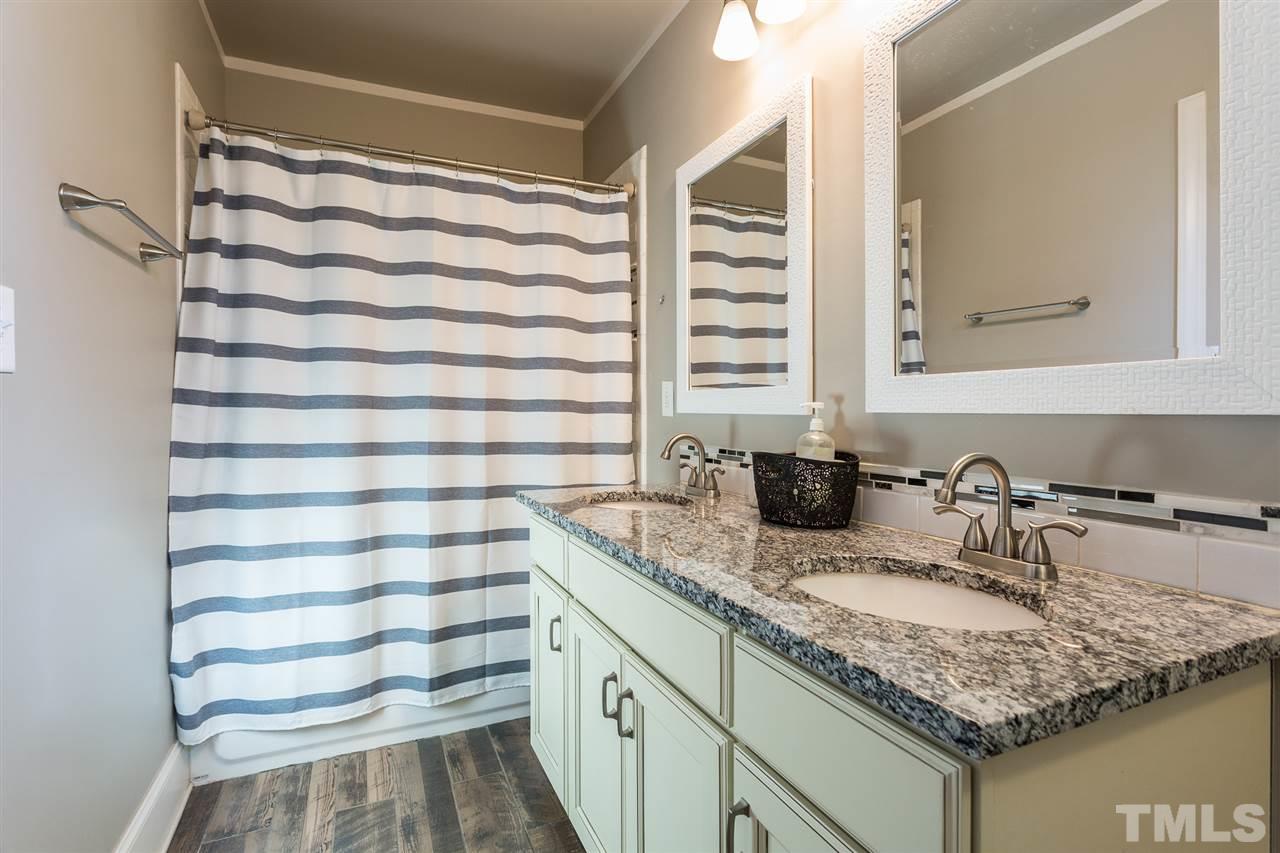 575 East Cabarrus Street Raleigh, NC 27601 - Photo 10 of 20 a bathroom with a granite countertop sink and a mirror