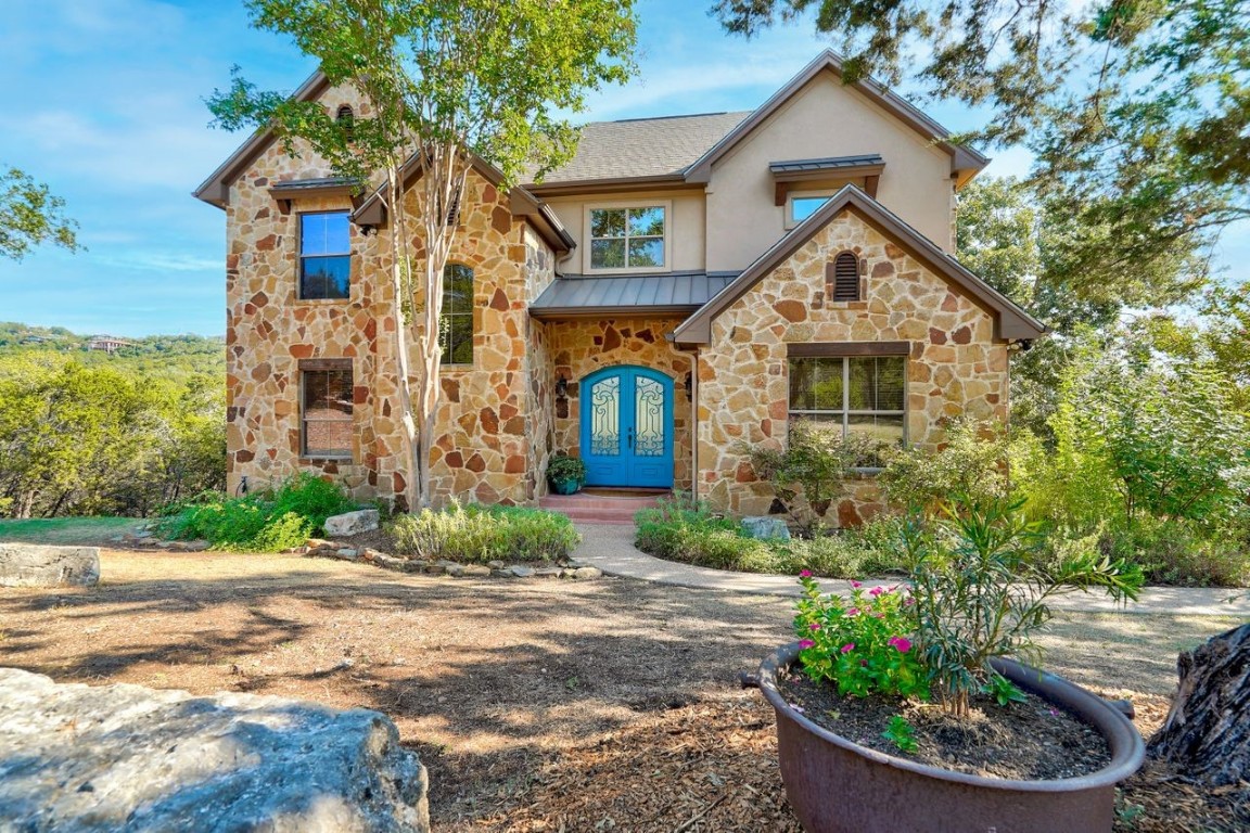 18202 West Reed Park Road Jonestown, TX 78645 - Photo 1 of 1 a front view of a house with garden