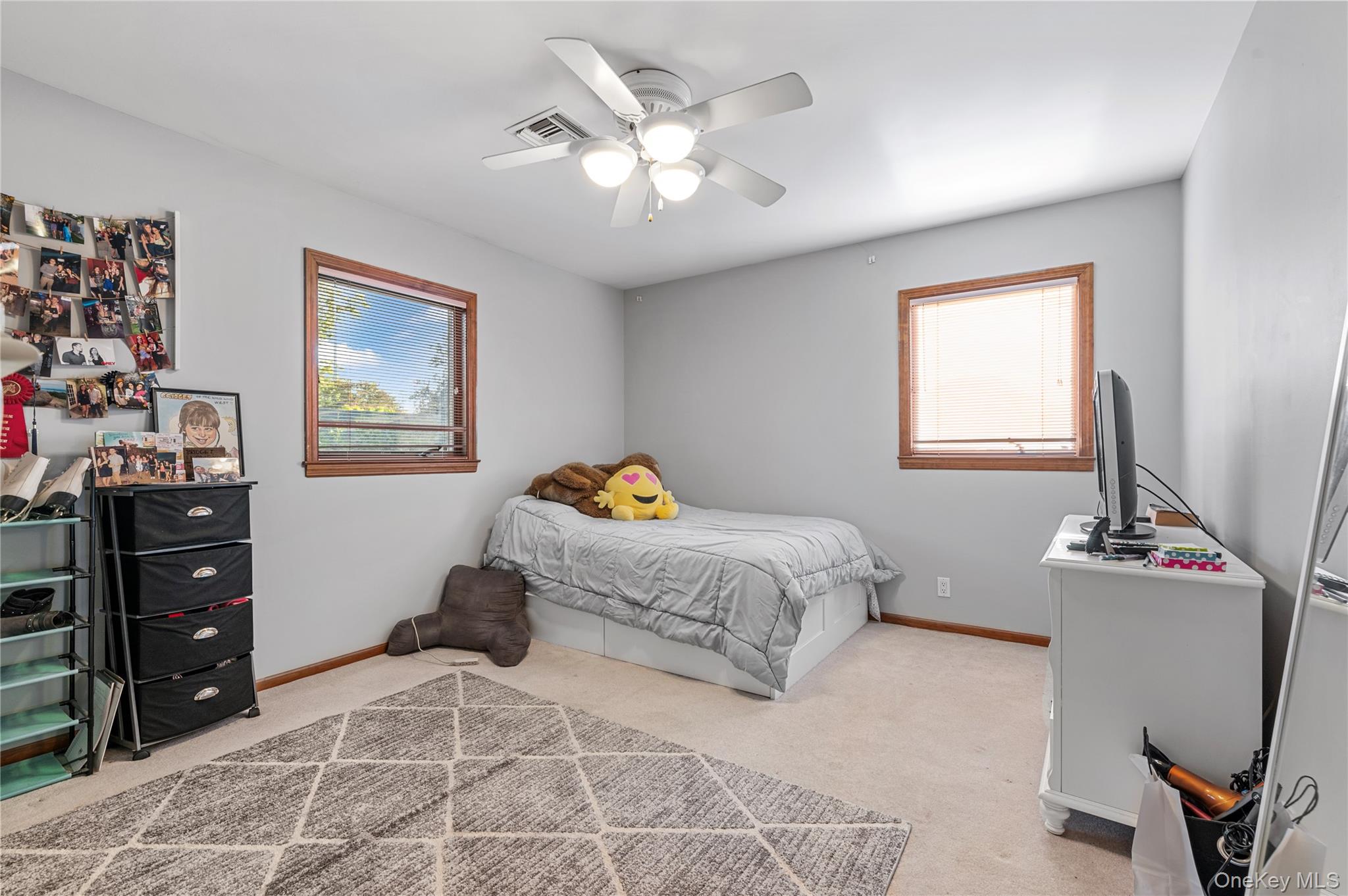 287 East Rockaway Road Hewlett, NY 11557 - Photo 13 of 25 a bedroom with a bed and a chandelier