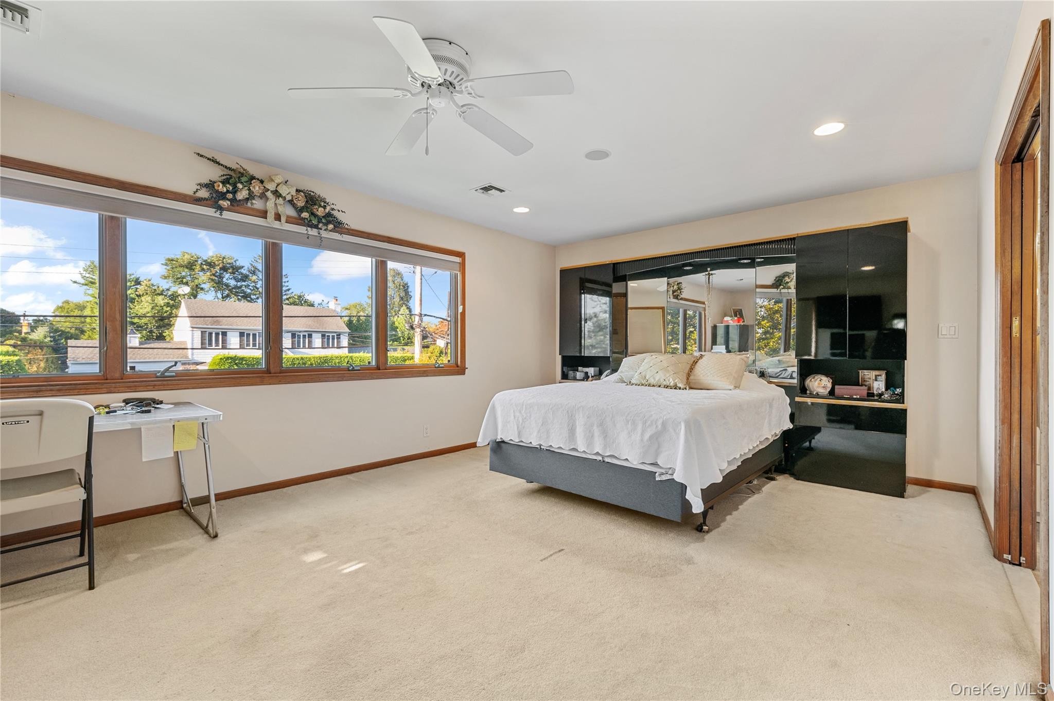 287 East Rockaway Road Hewlett, NY 11557 - Photo 17 of 25 a bedroom with a large bed and a large window