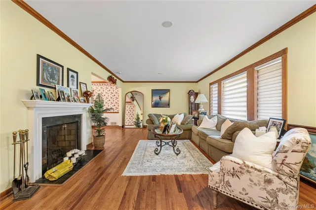 a living room with furniture a fireplace and a large window