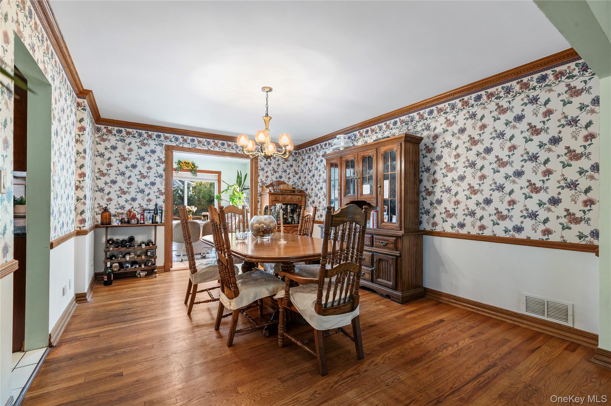 287 East Rockaway Road Hewlett, NY 11557 - Photo 7 of 25 a view of a dining room with furniture and wooden floor