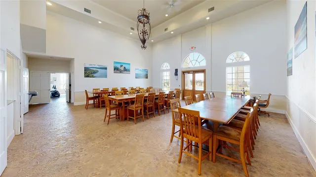 a view of a dining room with furniture and a chandelier
