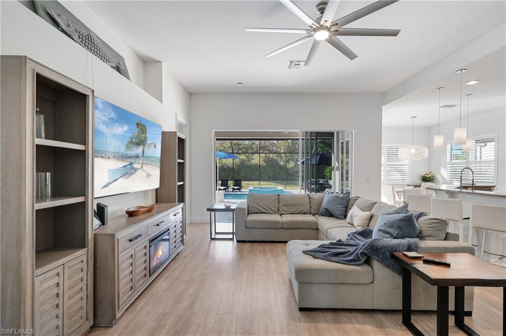 9121 Quartz Lane Naples, FL 34120 - Photo 12 of 36 Living room featuring ceiling fan and light wood finished floors