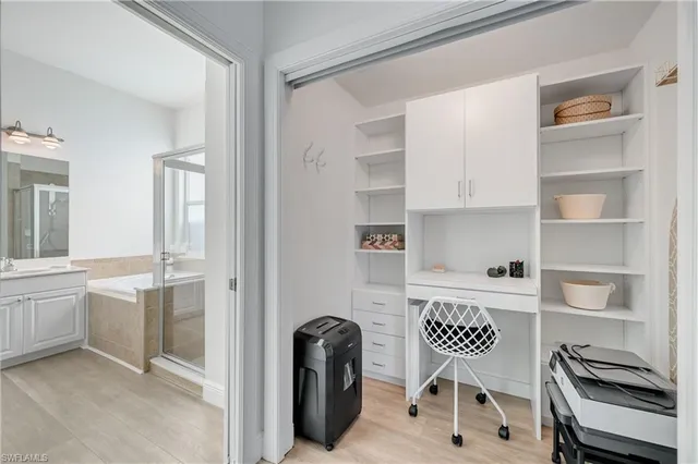 a kitchen with a chair a refrigerator and wooden floor