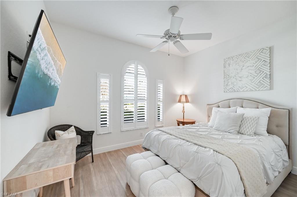 9121 Quartz Lane Naples, FL 34120 - Photo 15 of 36 Bedroom featuring wood finished floors and ceiling fan