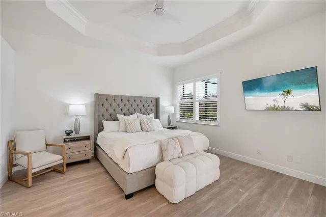 a bedroom with a bed lamp and a couch