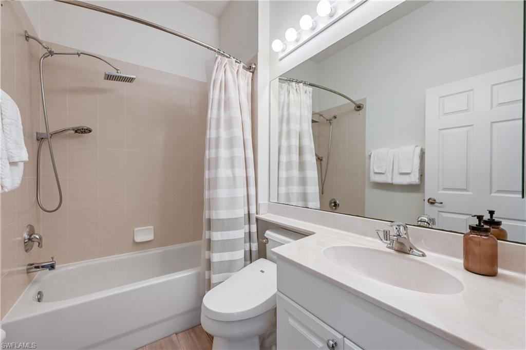 9121 Quartz Lane Naples, FL 34120 - Photo 20 of 36 Bathroom featuring vanity and shower / bathtub combination with curtain
