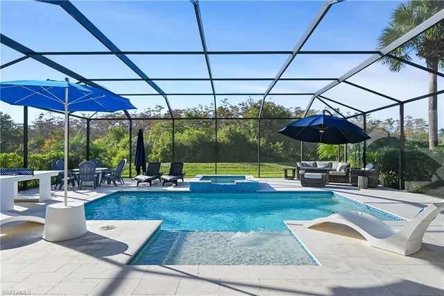 a view of a patio with a table and chairs under an umbrella