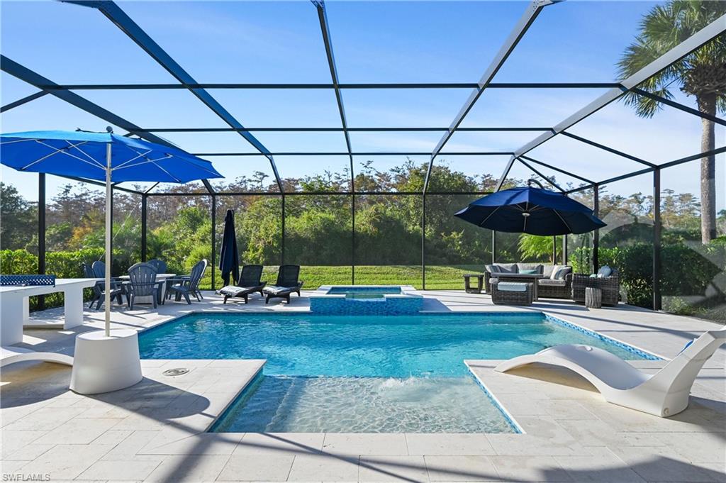 9121 Quartz Lane Naples, FL 34120 - Photo 22 of 36 View of swimming pool with a sunroom, a pool with connected hot tub, a patio area, and a lanai