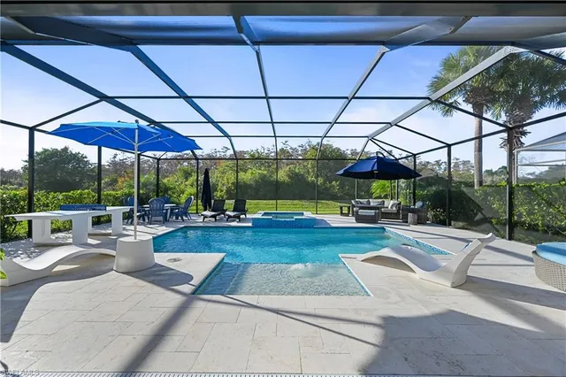 a view of a patio with a table and chairs under an umbrella