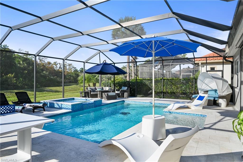 9121 Quartz Lane Naples, FL 34120 - Photo 25 of 36 View of swimming pool with a sunroom, outdoor lounge area, a pool with connected hot tub, a lanai, and a patio area