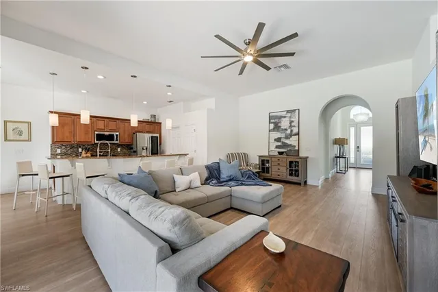 a living room with furniture and kitchen view