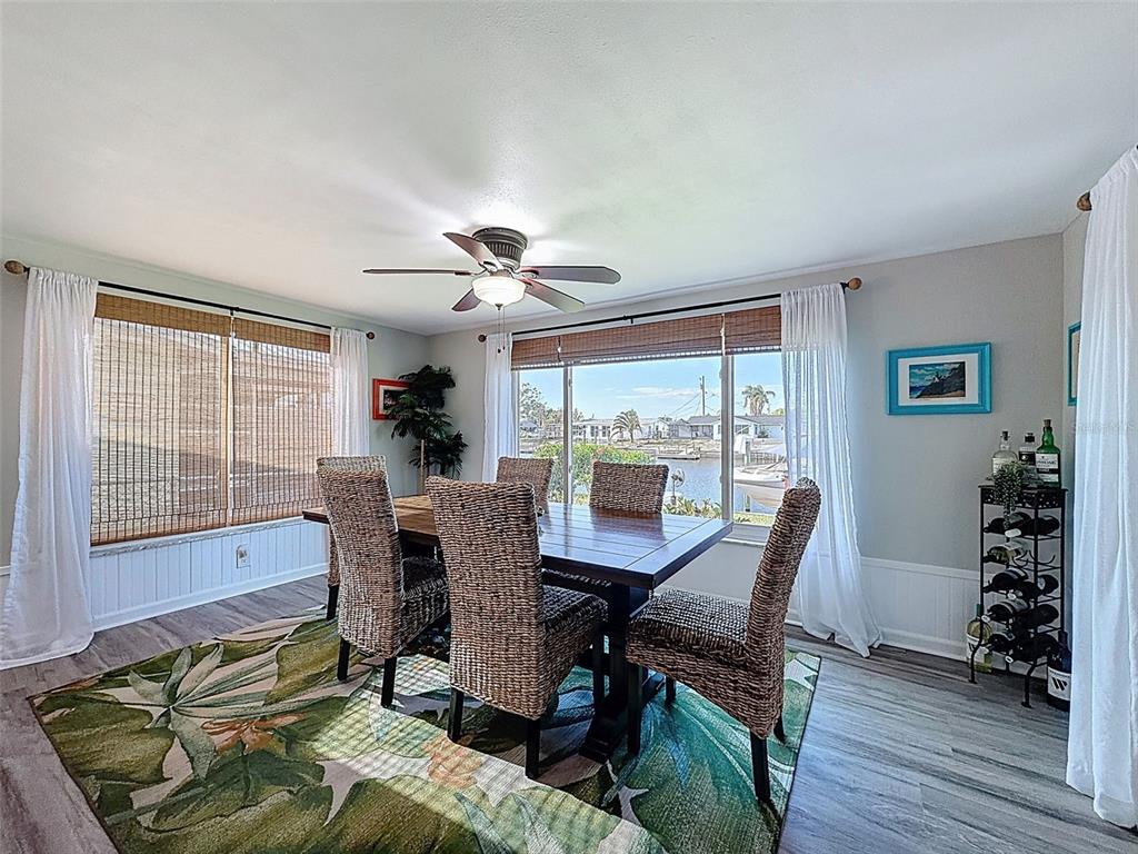 6521 Leeside Isle Hudson, FL 34667 - Photo 15 of 59 a view of a dining room with furniture window and wooden floor
