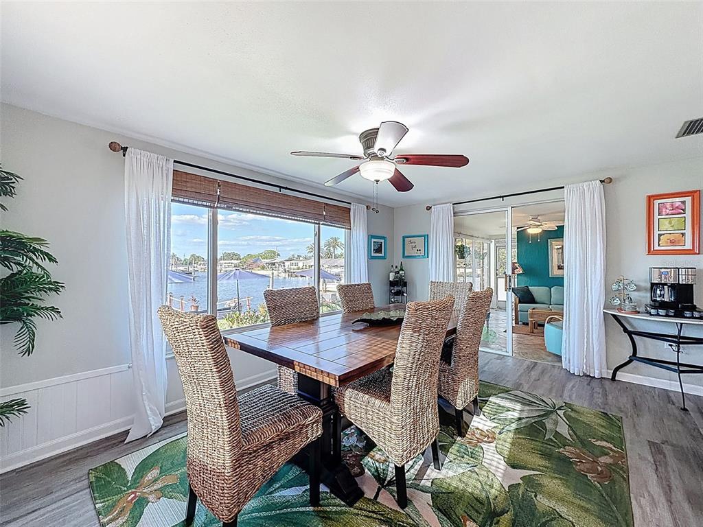 6521 Leeside Isle Hudson, FL 34667 - Photo 16 of 59 a view of a dining room with furniture window and wooden floor