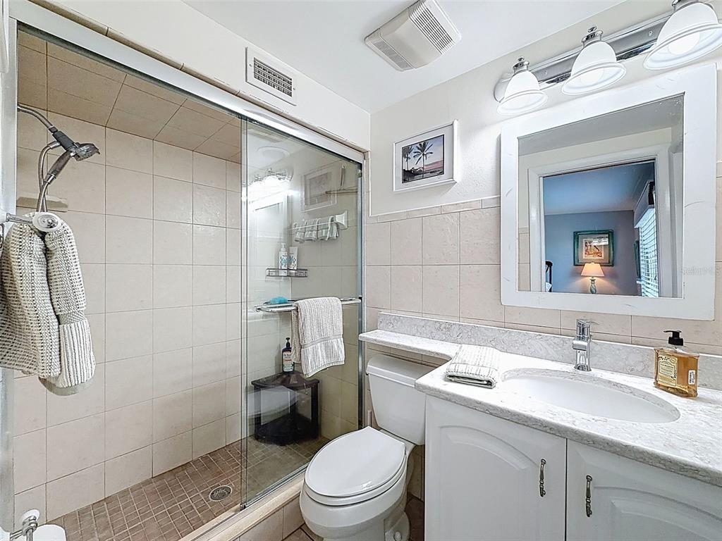 6521 Leeside Isle Hudson, FL 34667 - Photo 27 of 59 a bathroom with a sink toilet and shower