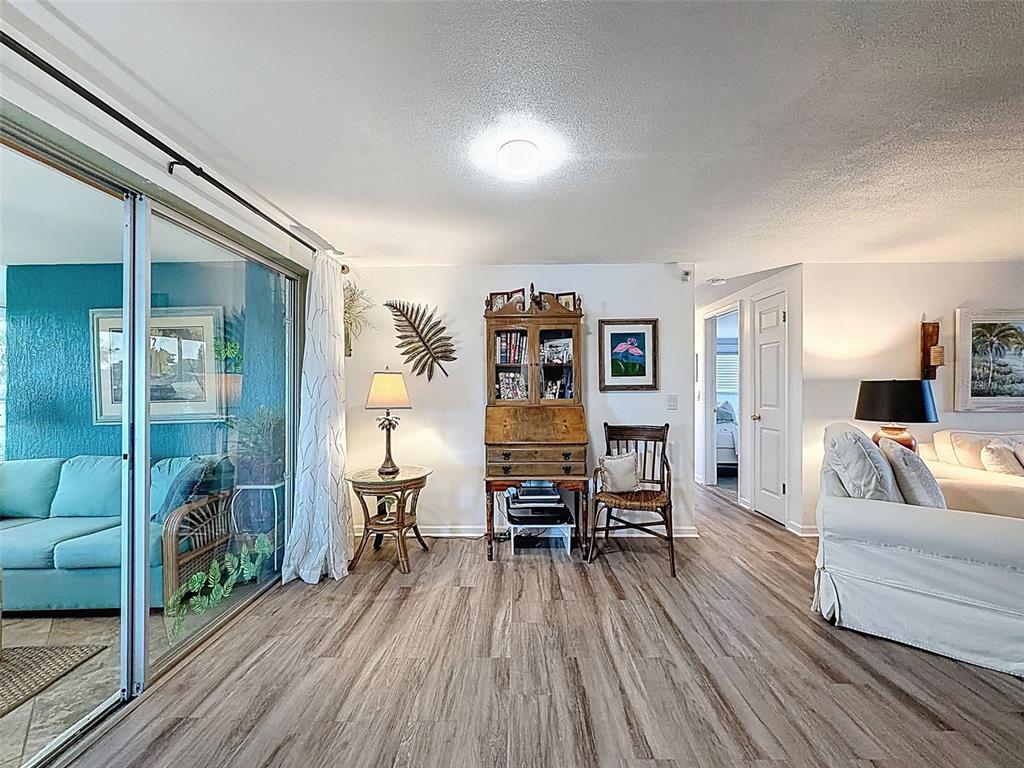 6521 Leeside Isle Hudson, FL 34667 - Photo 29 of 59 a living room with furniture and a wooden floor