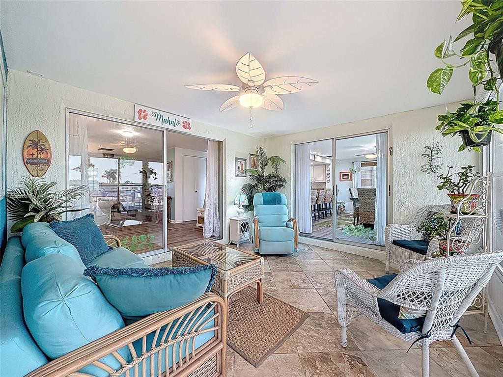 6521 Leeside Isle Hudson, FL 34667 - Photo 30 of 59 a living room with furniture a chandelier and a dining table