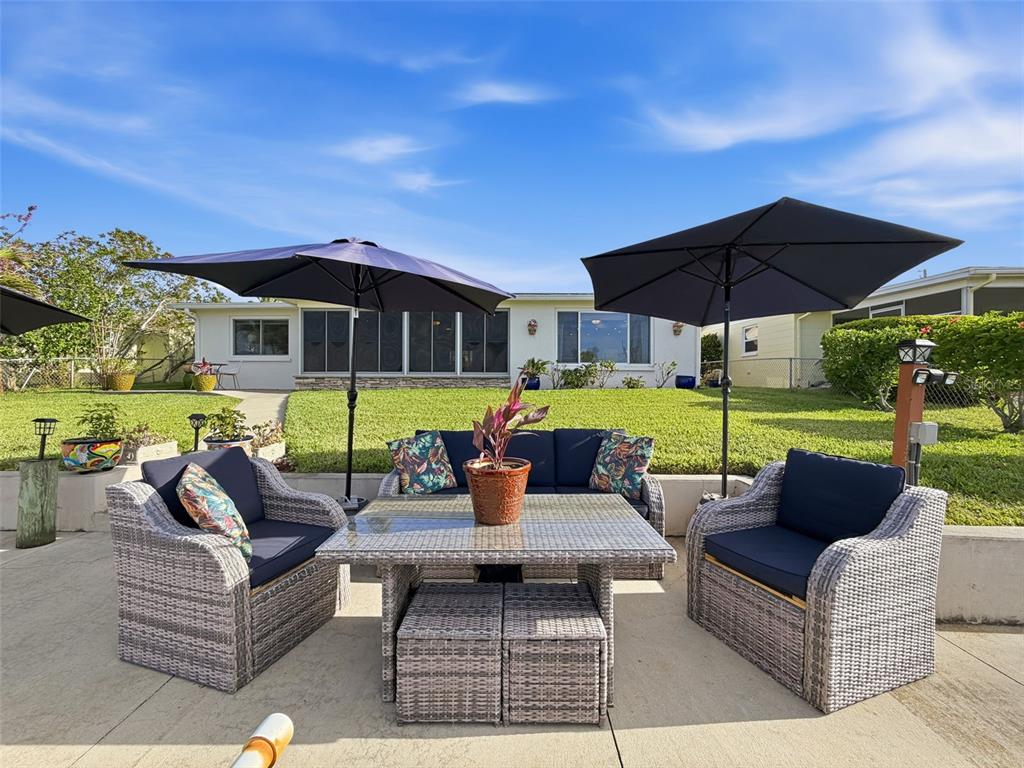6521 Leeside Isle Hudson, FL 34667 - Photo 38 of 59 a view of a patio with couches and potted plants