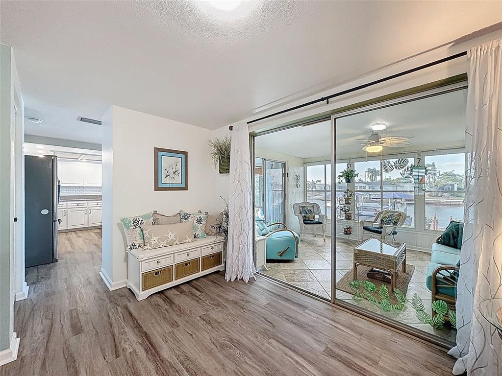 6521 Leeside Isle Hudson, FL 34667 - Photo 10 of 59 a living room with furniture and a floor to ceiling window