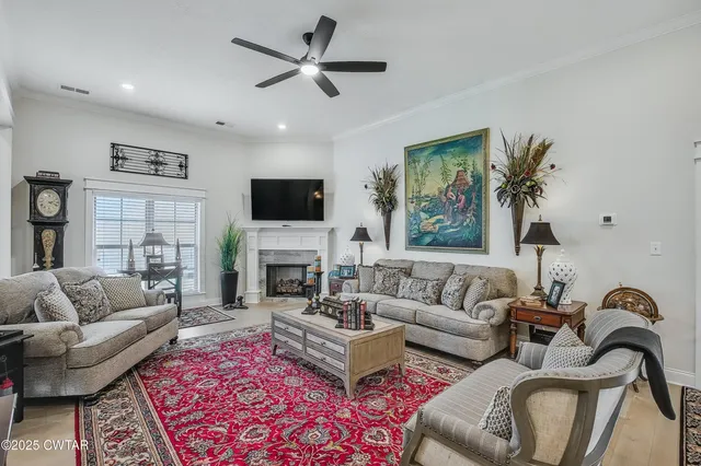a living room with furniture a rug and a flat screen tv