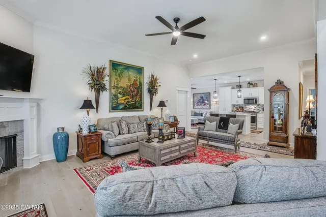 a living room with furniture fireplace and flat screen tv