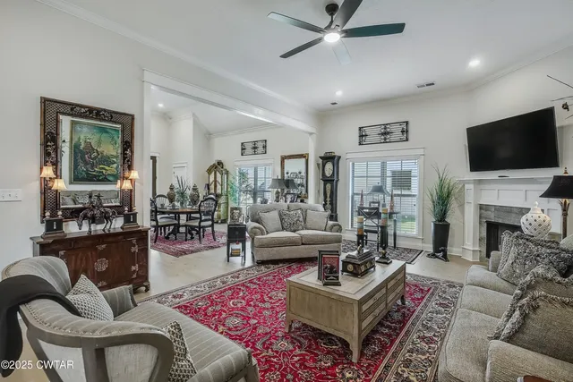 a living room with fireplace furniture and a flat screen tv