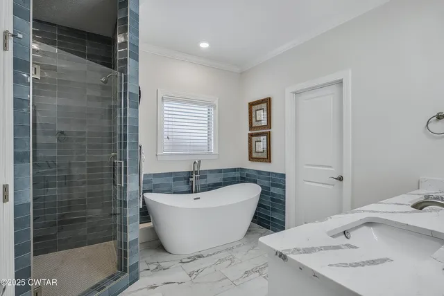 a white bath tub sitting next to a white sink