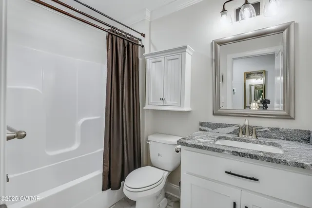 a living room with furniture a window and a flat screen tv