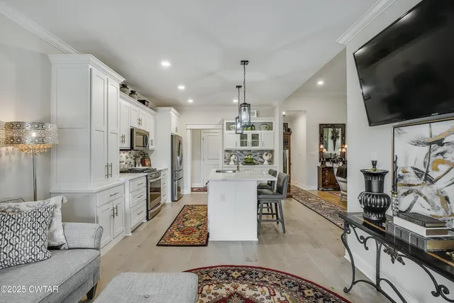 a kitchen with white cabinets and appliances
