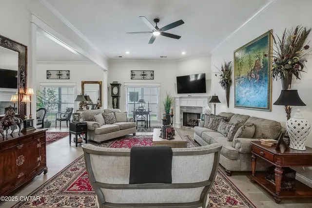 a living room with furniture fireplace and a flat screen tv