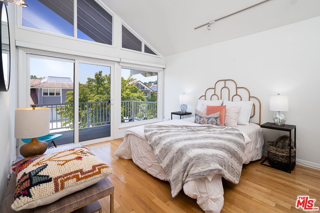 2866 Angelo Drive Los Angeles, CA 90077 - Photo 16 of 31 a bedroom with bed and a large window