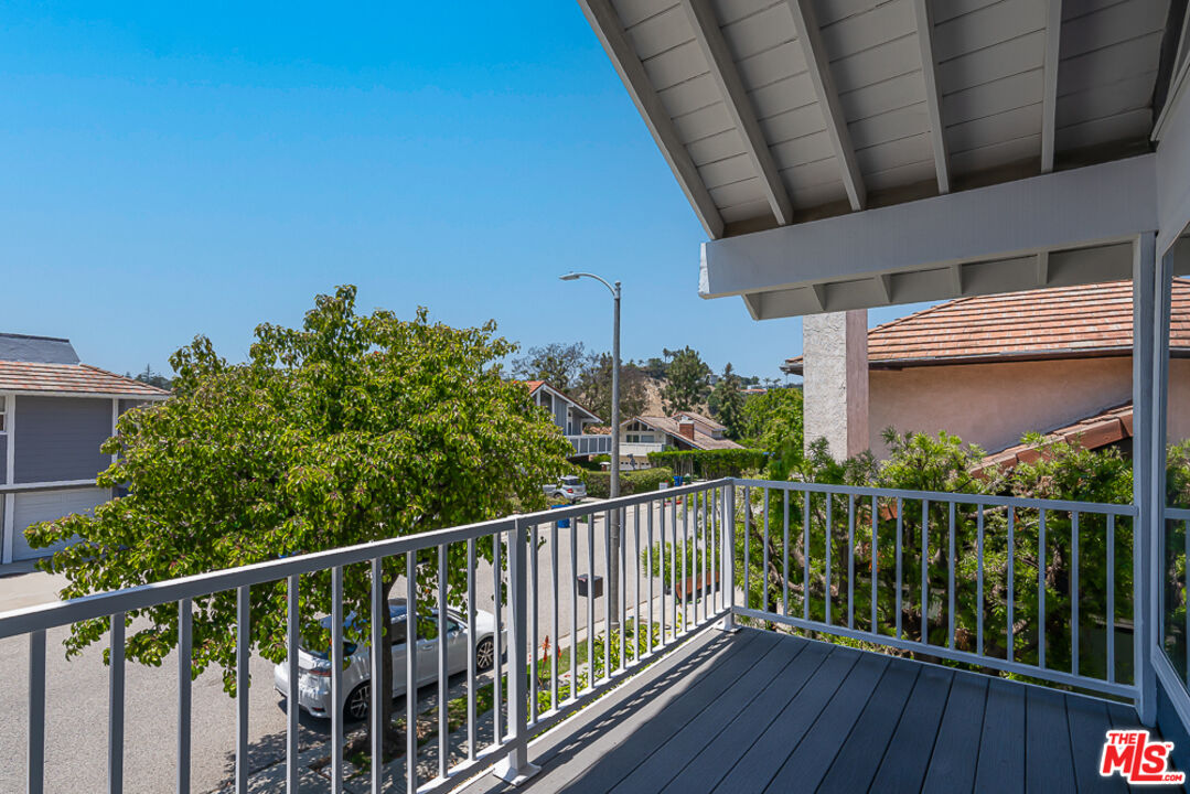 2866 Angelo Drive Los Angeles, CA 90077 - Photo 17 of 31 a view of a balcony with wooden fence