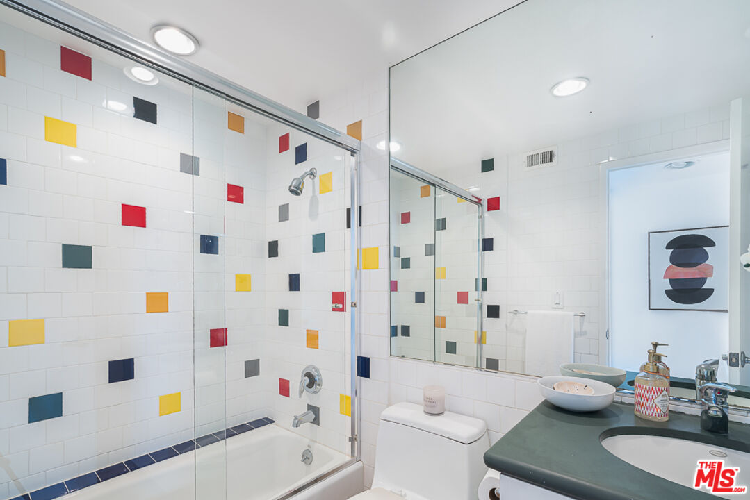 2866 Angelo Drive Los Angeles, CA 90077 - Photo 18 of 31 a bathroom with a sink a toilet and a shower curtain