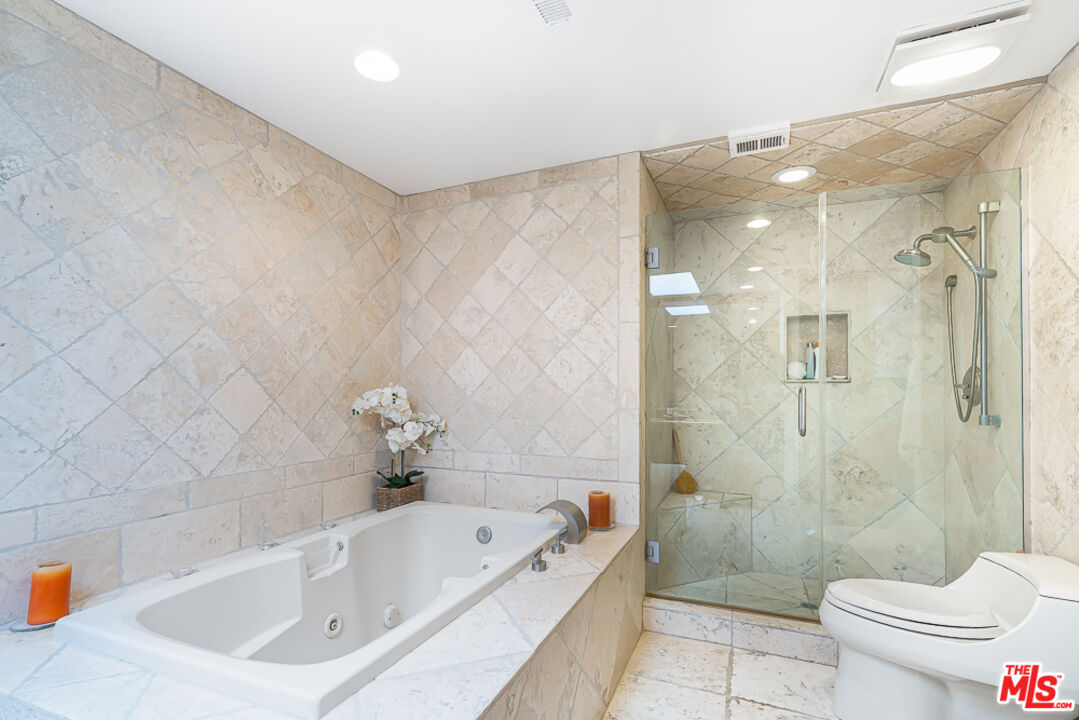 2866 Angelo Drive Los Angeles, CA 90077 - Photo 22 of 31 a bathroom with a tub a toilet and a shower