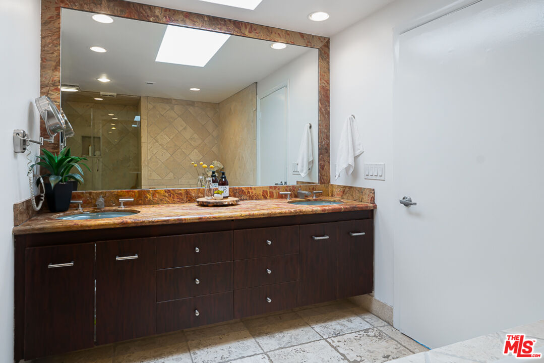 2866 Angelo Drive Los Angeles, CA 90077 - Photo 23 of 31 a bathroom with a sink and a mirror