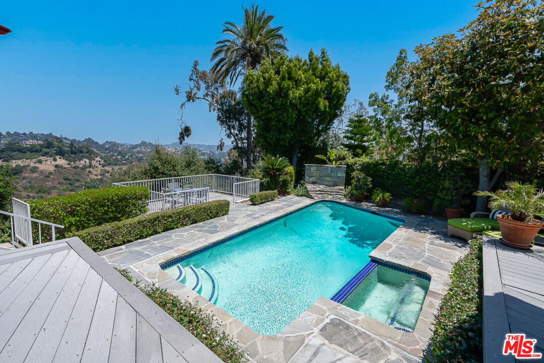 2866 Angelo Drive Los Angeles, CA 90077 - Photo 26 of 31 a view of a backyard with a patio and lake view