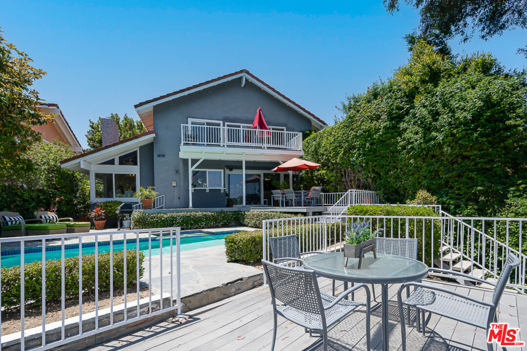 2866 Angelo Drive Los Angeles, CA 90077 - Photo 29 of 31 a view of house with a swimming pool and outdoor seating