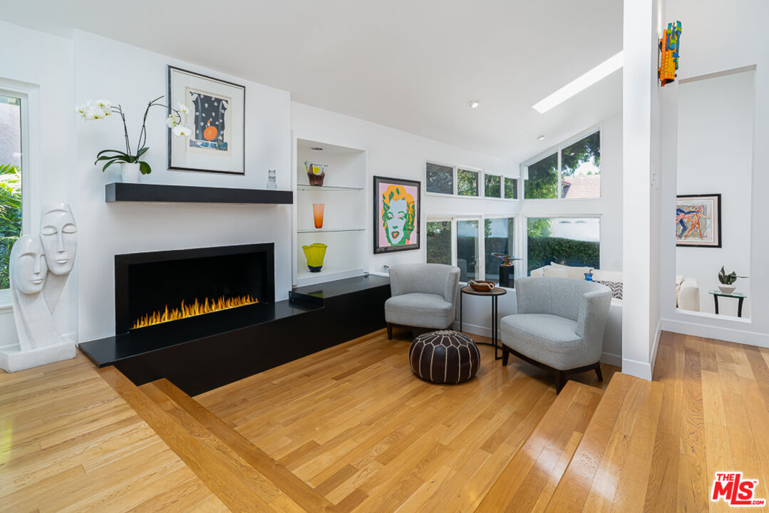 2866 Angelo Drive Los Angeles, CA 90077 - Photo 5 of 31 a living room with furniture and a fireplace