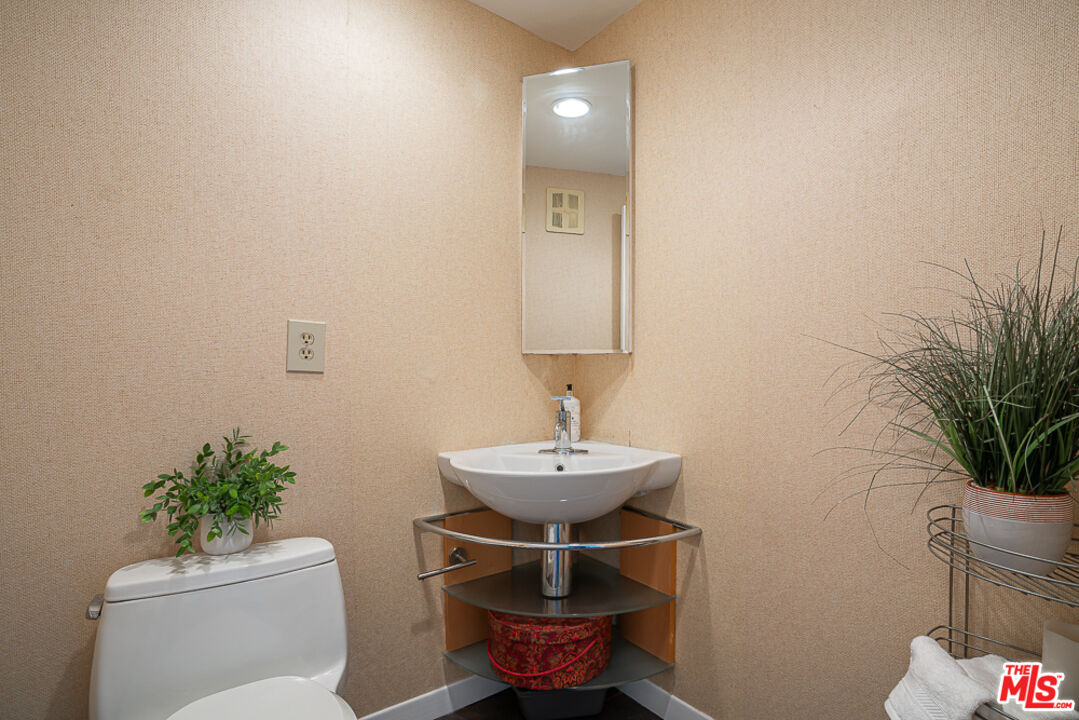 2866 Angelo Drive Los Angeles, CA 90077 - Photo 9 of 31 a bathroom with a toilet sink and mirror