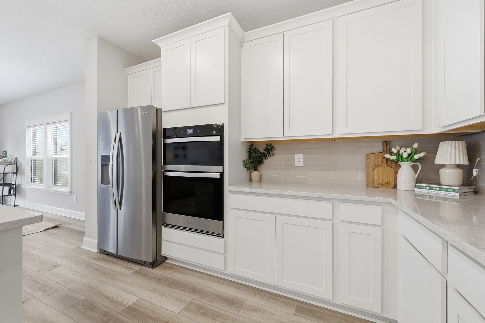 95026 Rocky Place Fernandina Beach, FL 32034 - Photo 16 of 53 a kitchen with white cabinets and refrigerator