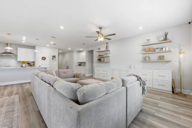 a spacious bedroom with a bed and a ceiling fan